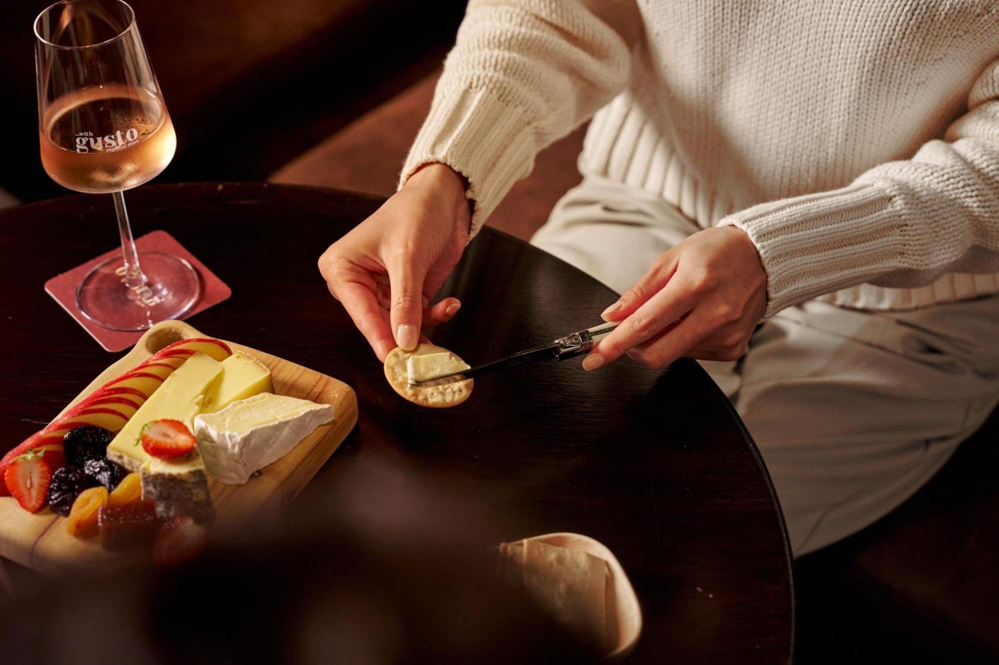 Sheraton Melbourne Hotel Bagian luar foto A woman spreading butter on a cracker